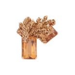 A large Modernist citrine brooch, of naturalistic design, cast surmounts superimposed upon two emera