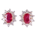 A pair of ruby and diamond cluster earrings, the central oval-cut rubies measuring approximately 6.0