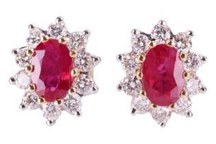 A pair of ruby and diamond cluster earrings, the central oval-cut rubies measuring approximately 6.0