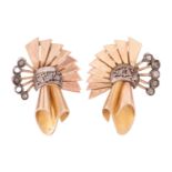 A pair of diamond set scroll earrings, circa 1940s, in a scrolling spray design set with diamond chi