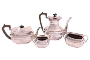 A four piece tea service, curved rectangular, panelled form with angled handles, the teapot and