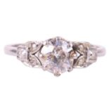 An old cut diamond solitaire ring with diamond set shoulders, circa 1920s, featuring a round old cut