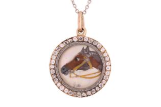 An Essex crystal horsehead pendant on a platinum chain, the round domed crystal with painted reverse