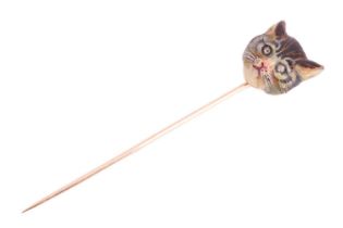 An Edwardian cat head enamel stick pin, sculpted as a realistic head of a tabby cat, painted with