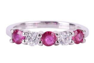A pink sapphire and diamond five-stone ring, featuring two round brilliant diamonds set between