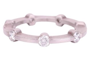 A diamond eternity ring, set with seven round brilliant cut diamonds evenly spaced around the