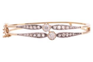 A Victorian diamond-set double row hinged bangle, featuring two old-cut diamonds in buttercup