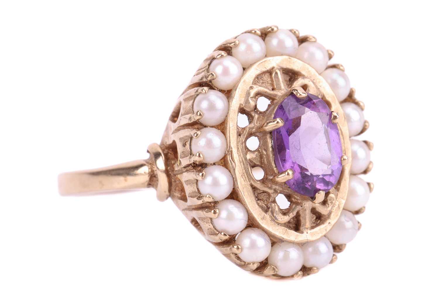 An amethyst and seed pearl cluster ring, featuring an oval cut amethyst measuring 7 x 5 x 3.5mm, in  - Image 2 of 4