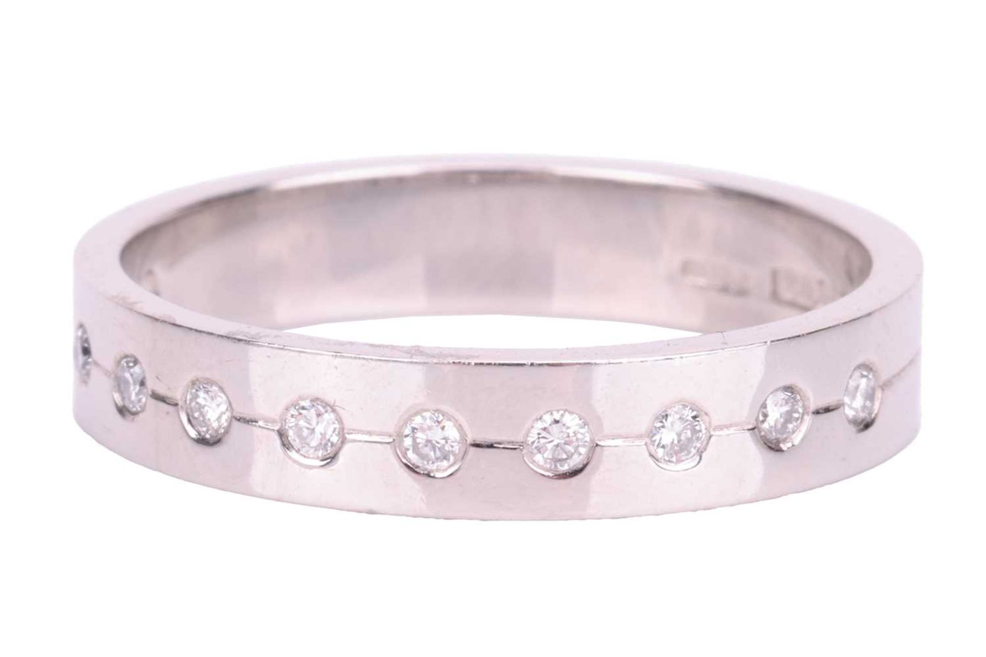 A diamond half eternity ring in platinum, set with a central row of eleven round brilliant cut diamo