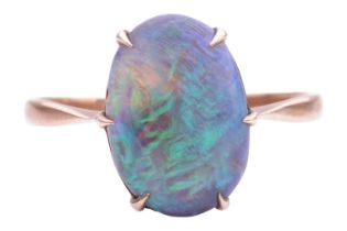 A black opal dress ring, featuring an oval precious opal cabochon approximately measuring 13.4 x 9.3