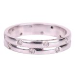 An 18ct white gold diamond-set ring, the double row band flush-set with sixteen round brilliant diam