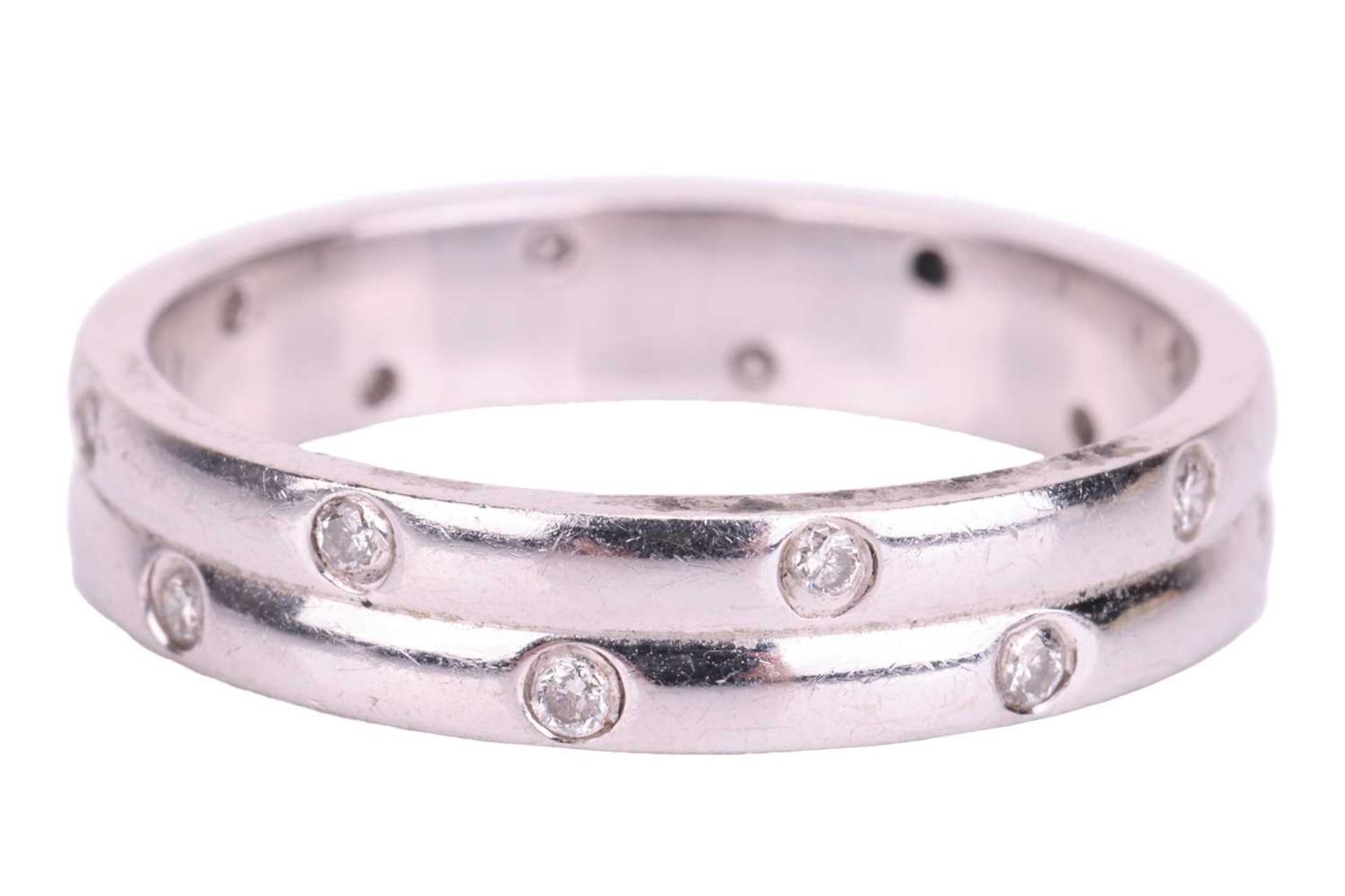 An 18ct white gold diamond-set ring, the double row band flush-set with sixteen round brilliant diam