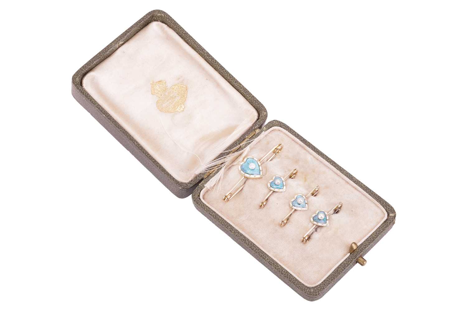 A set of four Edwardian seed pearl and enamel pins, each pin featuring a pale blue and white enamell