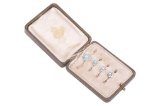 A set of four Edwardian seed pearl and enamel pins, each pin featuring a pale blue and white