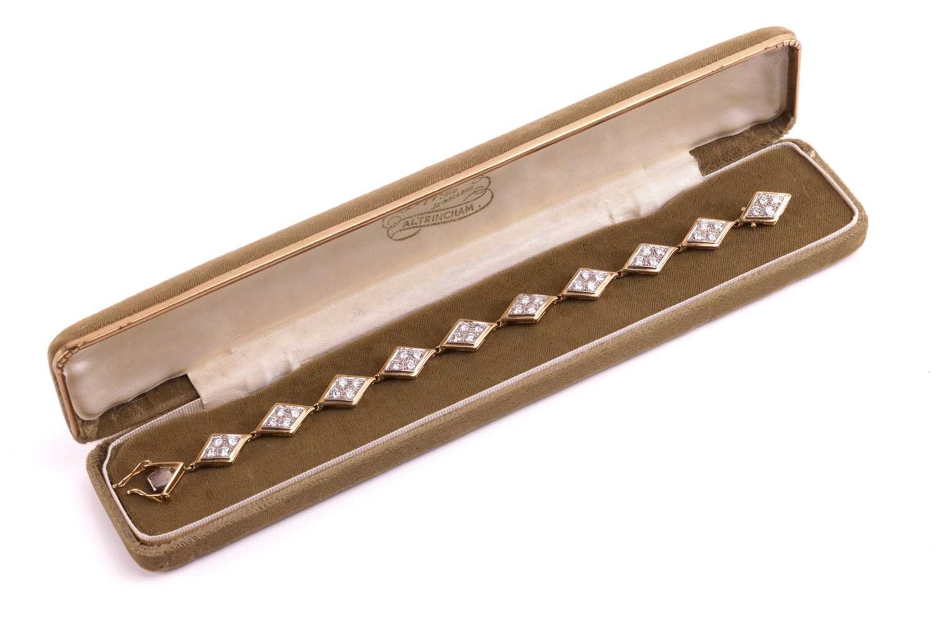 A diamond-set link bracelet in 18ct gold, comprising a series of lozenge-shaped panel links, each se