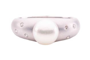A pearl and diamond dress ring, comprising a round white cultured pearl of 7.7 mm with pale rose ove