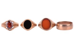 A collection of four rings, including a garnet single stone ring, the garnet measuring 10.2 x 8.2