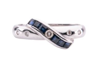 A sapphire and diamond ring with crossover design, calibré-set sapphires to the centre, and set with