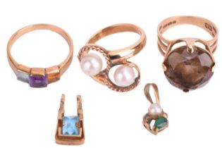 A collection of gold jewellery comprising a pearl crossover ring, a quartz ring, a multi-gem ring, a