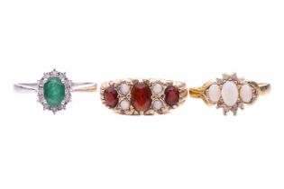 Three rings; including a 9ct yellow gold garnet and opal half-hoop ring with scrolling detail, hallm