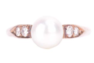 A cultured pearl and diamond ring featuring a central 7mm pearl leading to diamond set shoulders wit