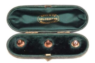 Three shirt studs in a fitted Hall &amp; Co Manchester box, in yellow metal one stamped 15ct. Total 