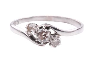 A three-stone diamond crossover ring, comprising three graduated diamonds with an estimated total