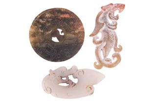 Three Chinese carved nephrite plaques; to include a circular bi of a mottled dark olive green