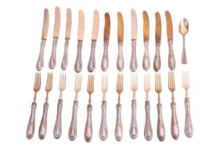 A set of German white metal handled eleven dessert knives and twelve dessert forks, the handles stam