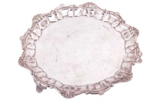 Lee &amp; Wigfull (Henry Wigfull):- A silver salver with shell and scroll rim on three fluted splaye
