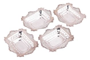 Goldsmiths Company:- A set of four silver bonbon dishes of pierced rectangular form the shaped rims 