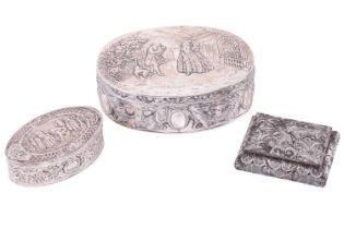A Continental silver box of oval form, the hinged cover with a repoussé scene of figures in a garden