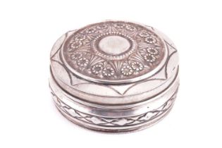 A Portuguese white metal dressing table box and cover, of cylindrical form with floral decoration, 1