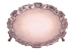 An Edwardian silver salver, by Edward Barnard &amp; Sons Ltd, London 1908, of circular form with pie