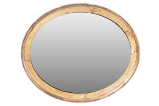 A Victorian oval gilt wood wall mirror with moulded surround, fitted with an aged replacement mirror