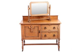 An Arts and Crafts restored oak sideboard, with two short drawers and a large single-shelved cupboar