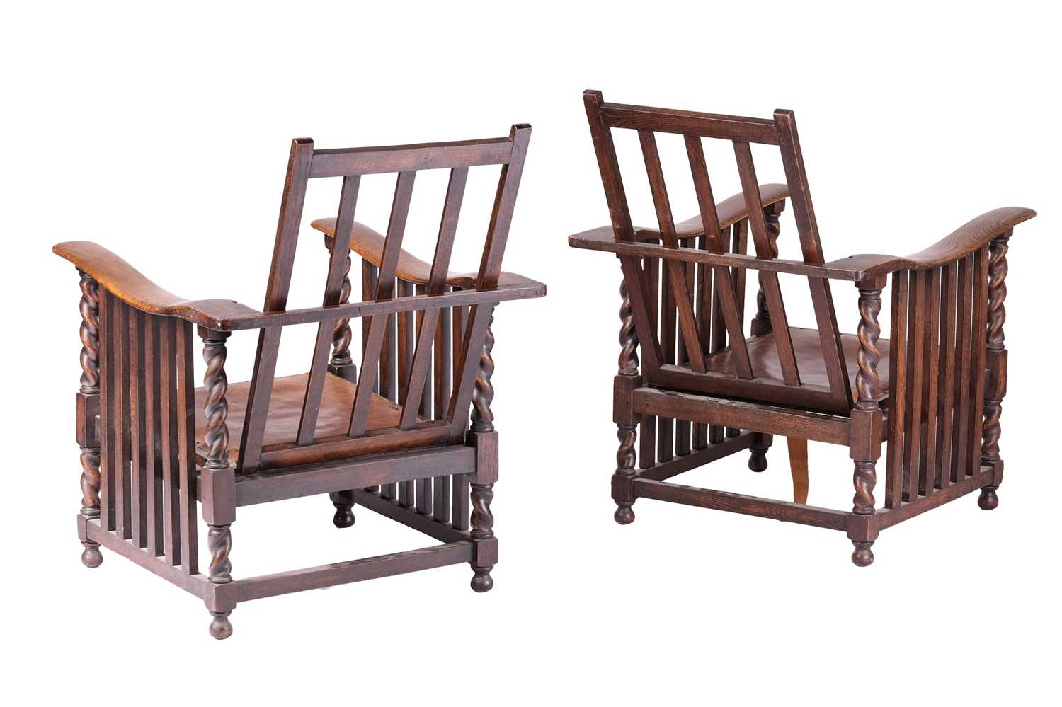 A pair of early twentieth-century reclining oak armchairs in the manner of Jas Shoolbred stood on bu - Image 4 of 6
