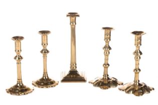 A pair of Queen Anne-style brass candlesticks, 21 cm high, together with a further pair of petal-bas