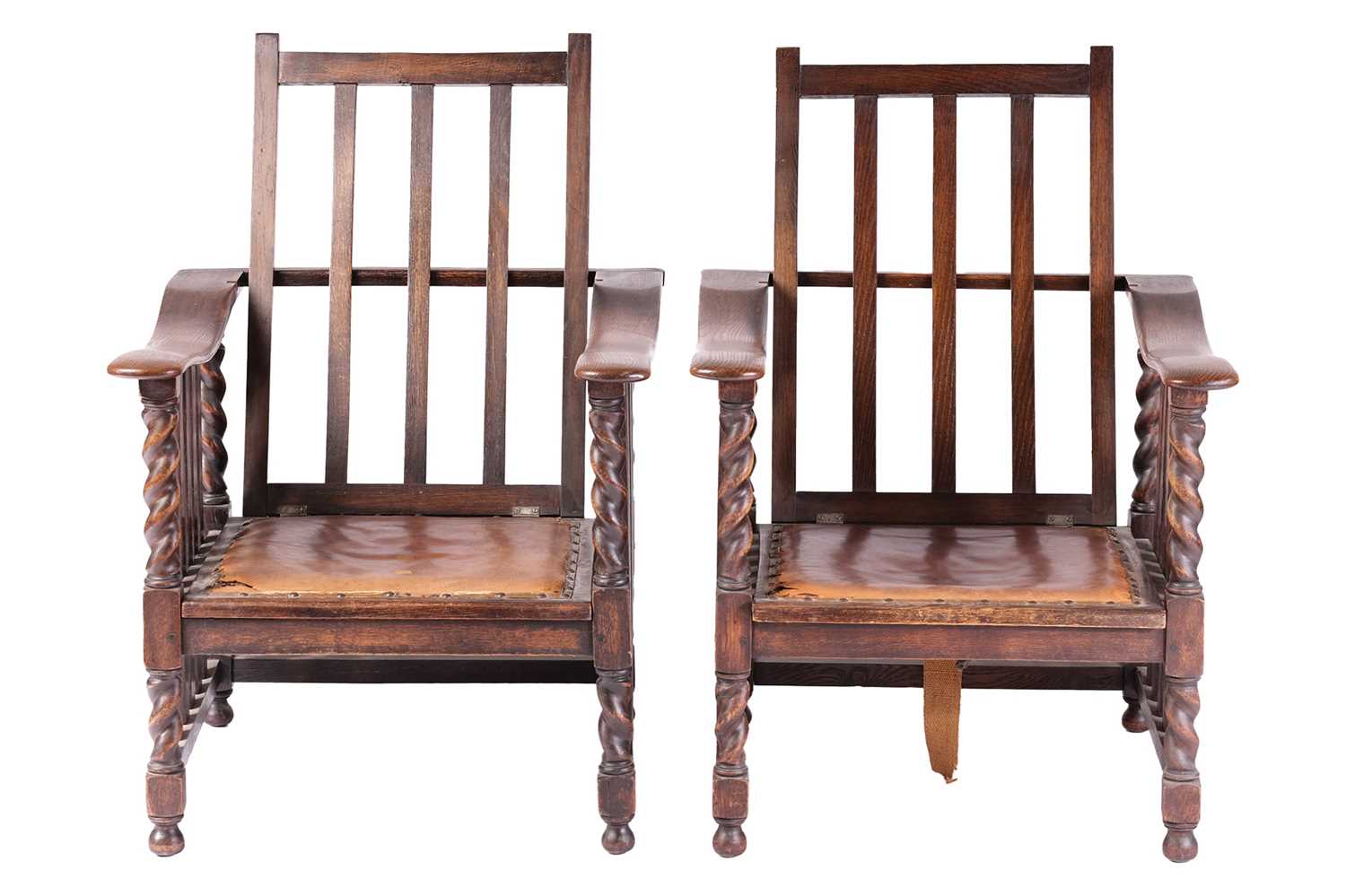 A pair of early twentieth-century reclining oak armchairs in the manner of Jas Shoolbred stood on bu - Image 2 of 6