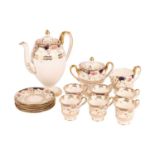 A Wedgwood floral patterned coffee set on white ground with blue and gold decoration, comprising of 