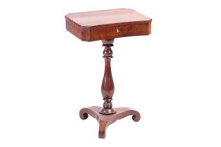 A French 19th-century figured rosewood pedestal work table with a fitted interior, over a concave