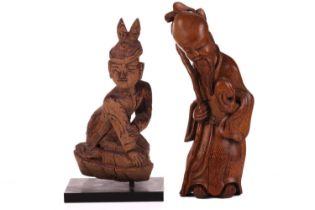 A Chinese-carved bamboo figure of Shou Lao, late Qing Dynasty with peach staff and bat peering