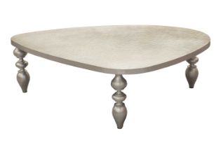A contemporary designer brushed aluminum pebble form coffee table with planished surface on three