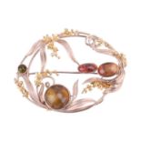 A tourmaline brooch by Polly Gasston, in a floral and foliate design in bi-colour gold set with cabo