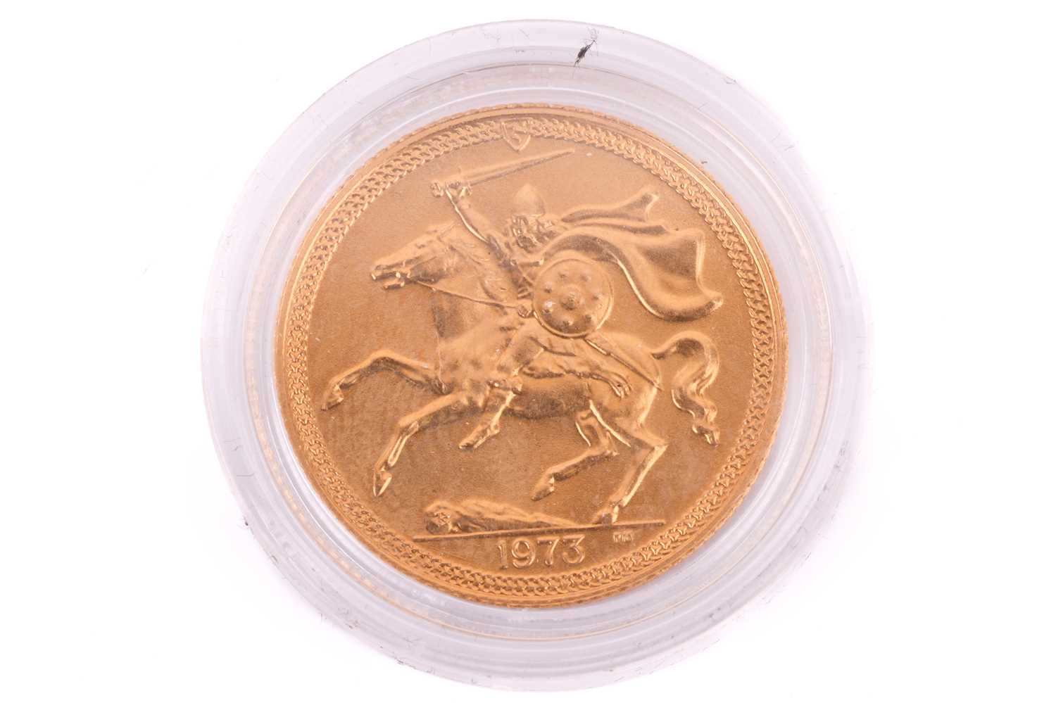 A 1973 Isle Of Man Elizabeth II Full-Sovereign with a plastic case, circulated.