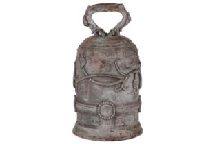 An archaistic Chinese bronze bell with a rustic loop handle the domed body with raised flowering