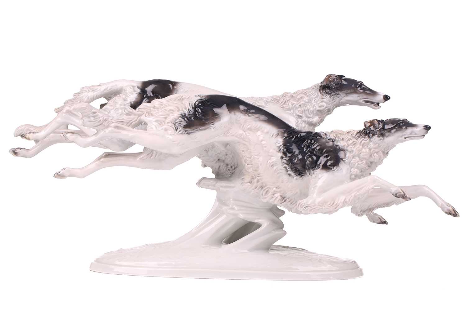 A Rosenthal porcelain figure of two Borzoi Wolfhounds racing, on an oval base, 61cm longWould benefi