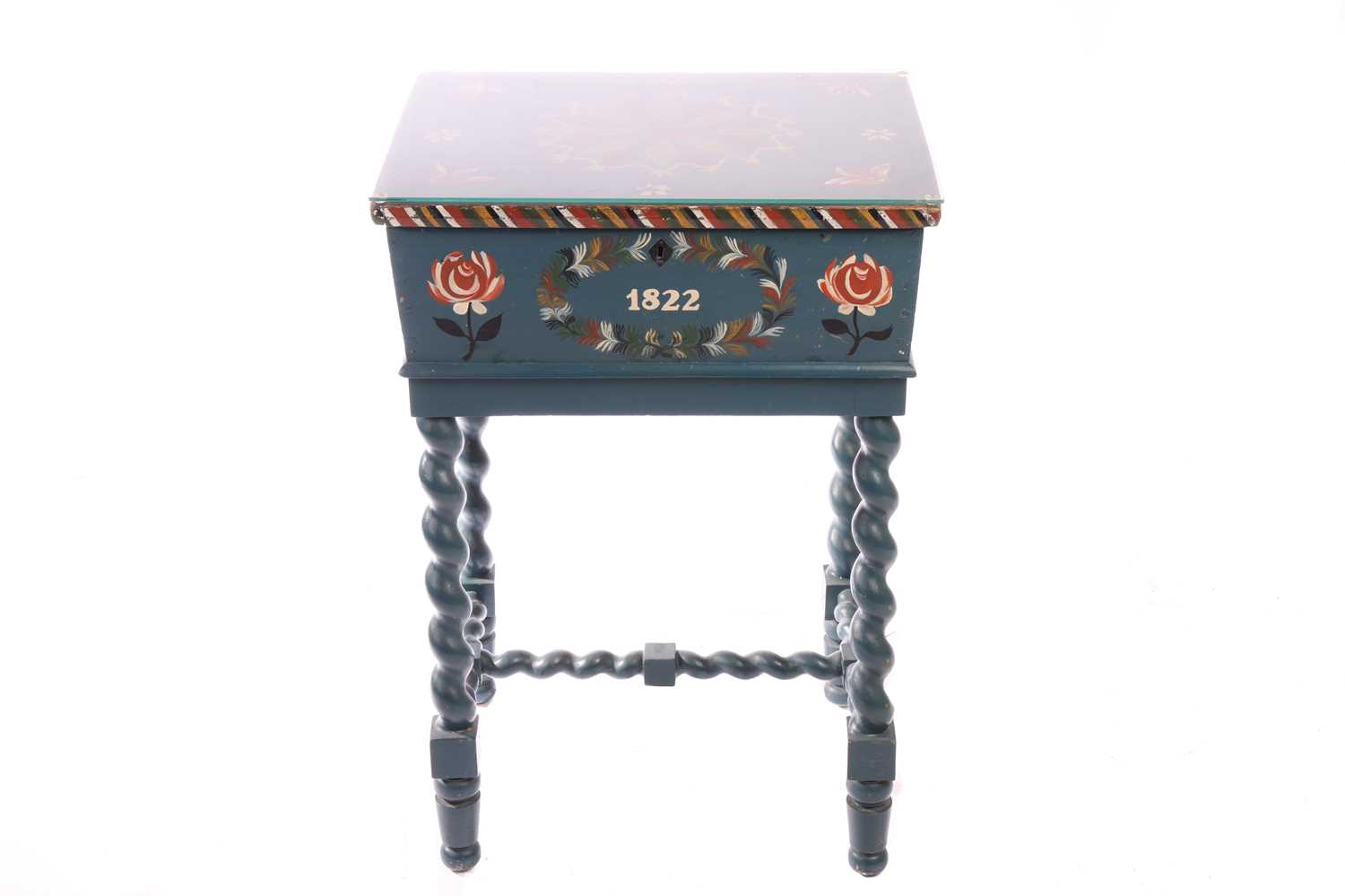 A Scandinavian teal-coloured painted bread bin, glass topped with a central floral boss flanked by f
