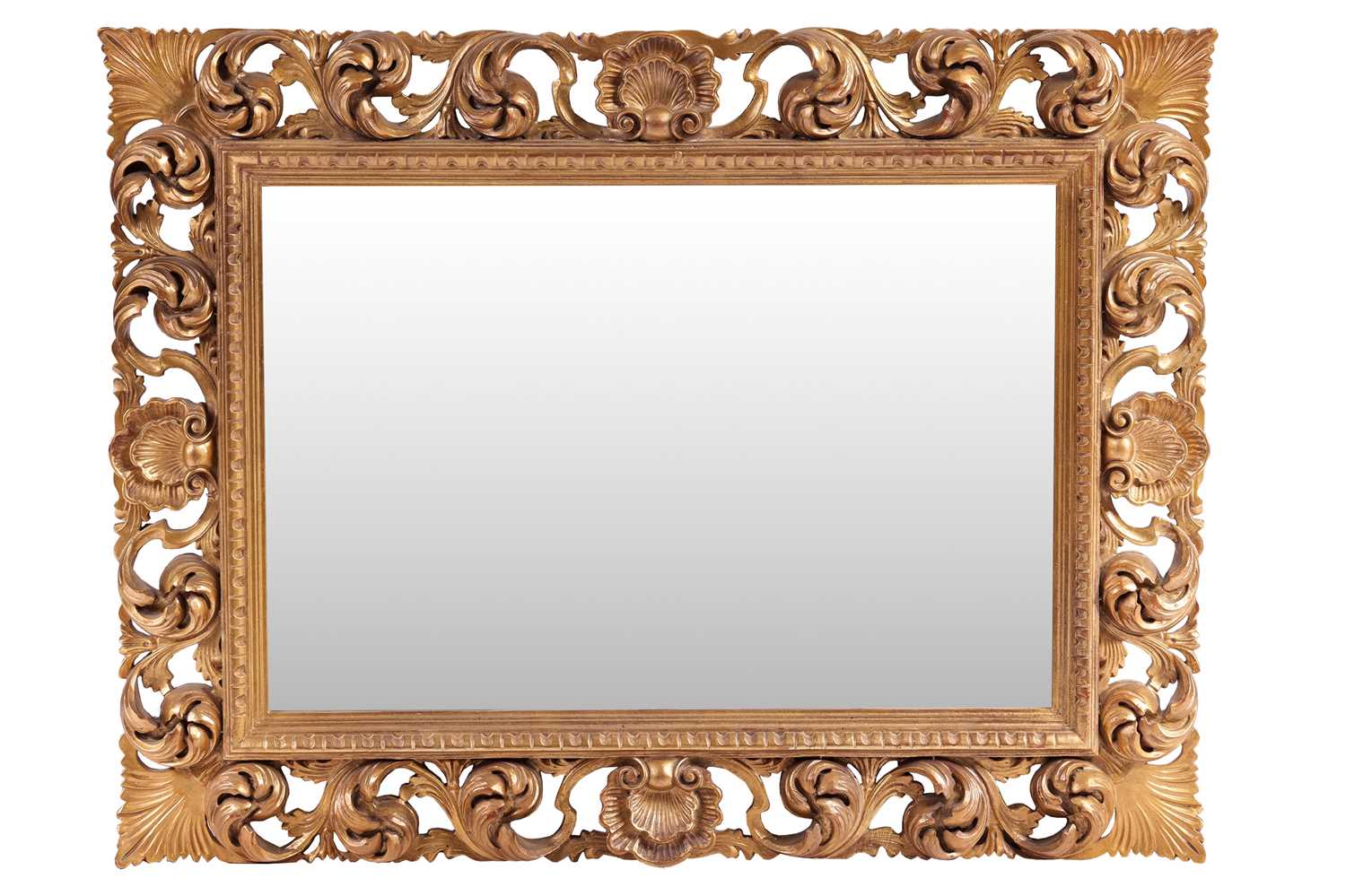 An 18th-century style heavy framed rectangular wall mirror with carved pierced and gilt scrolled sur