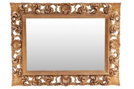 An 18th-century style heavy framed rectangular wall mirror with carved pierced and gilt scrolled sur